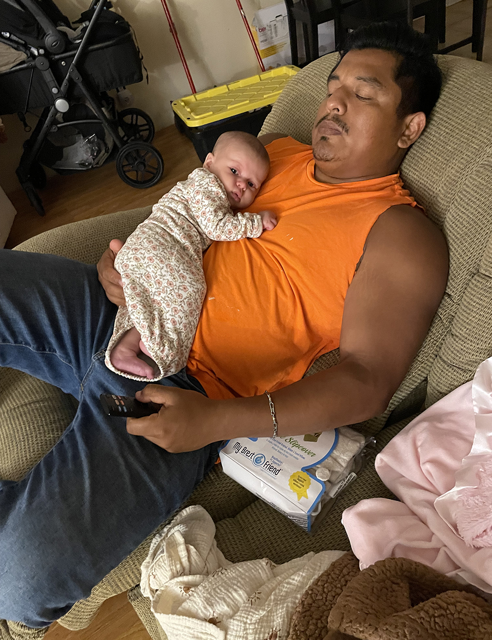 Gilbert sleeping with baby on chest